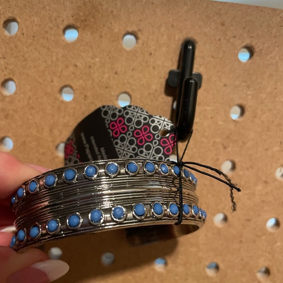 Silver strand cuff with tiny matte blue bead accents.